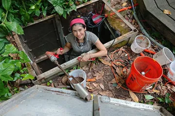 Student working in the soil pit of rain forest 